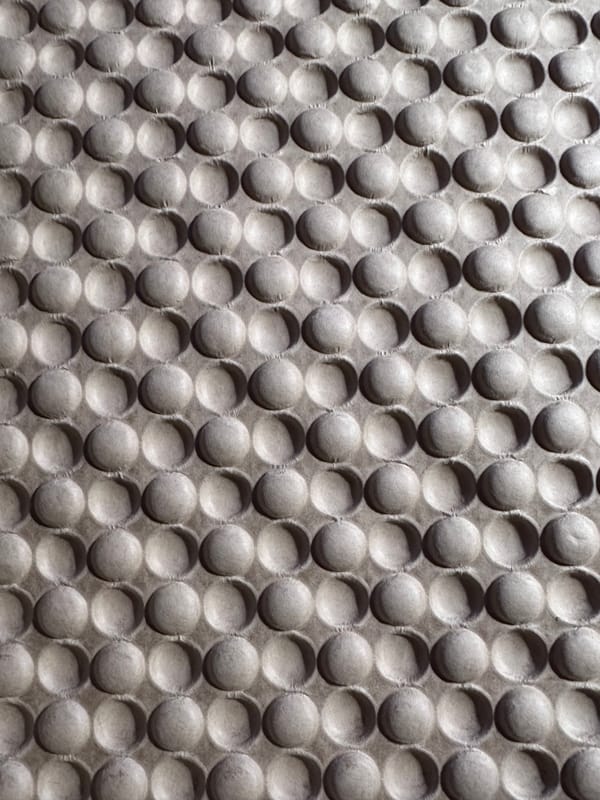 Dramatically lit embossed/debossed packing kraft paper that is almost like bubble wrap.